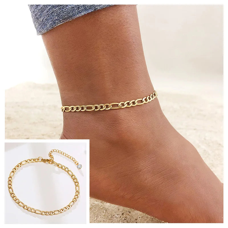 Gold stainless steel snake chain anklet worn on a woman's ankle.