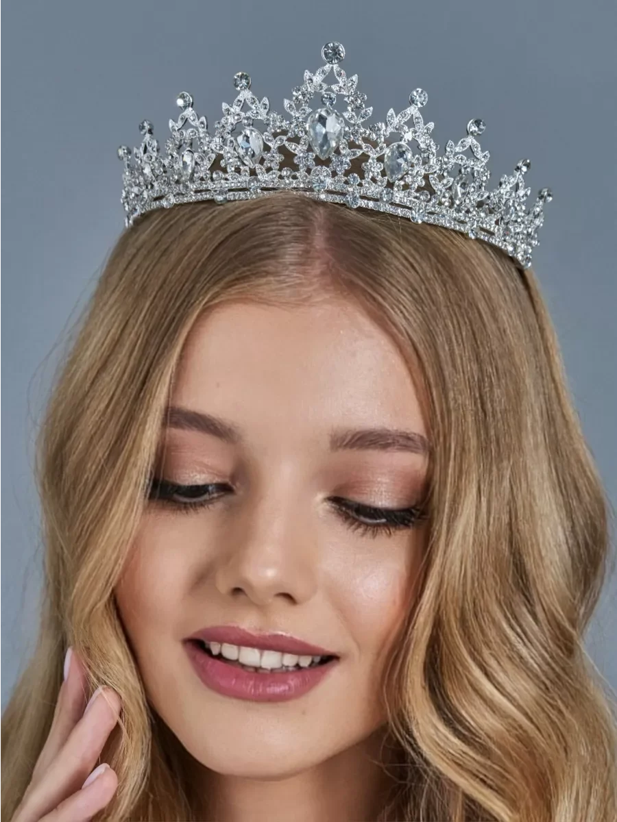 A blonde woman wearing an elegant crystal rhinestone tiara and headband set.