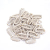 A pile of light beige hair extension snap clips for wigs.