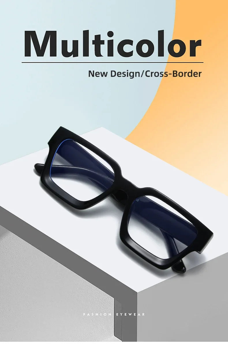 A pair of black square anti-blue light computer glasses with blue lenses resting on a white surface.