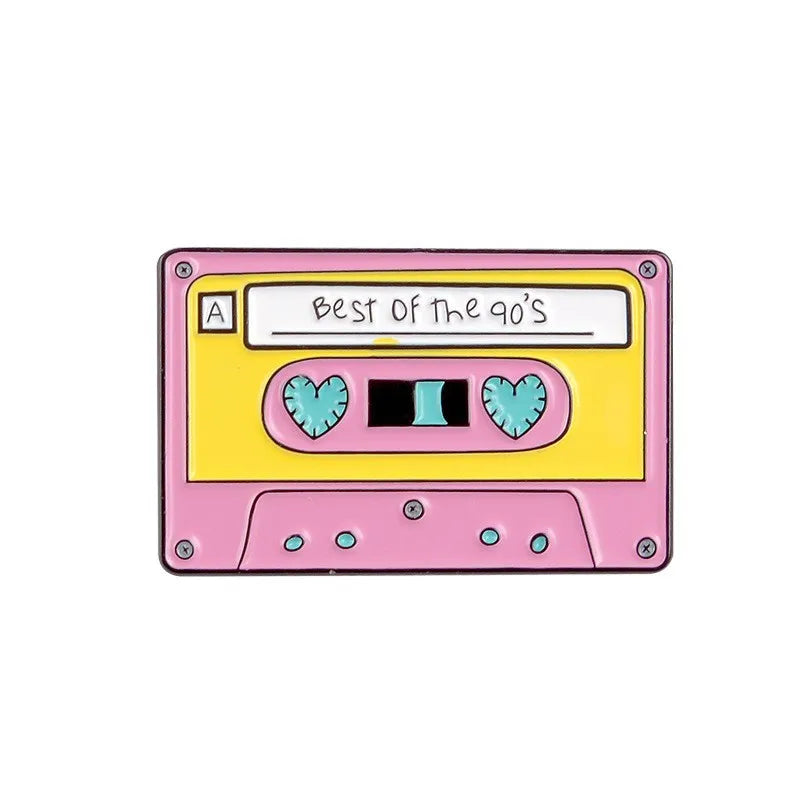 A pink and yellow retro cassette tape enamel pin featuring the text Best of the 90s