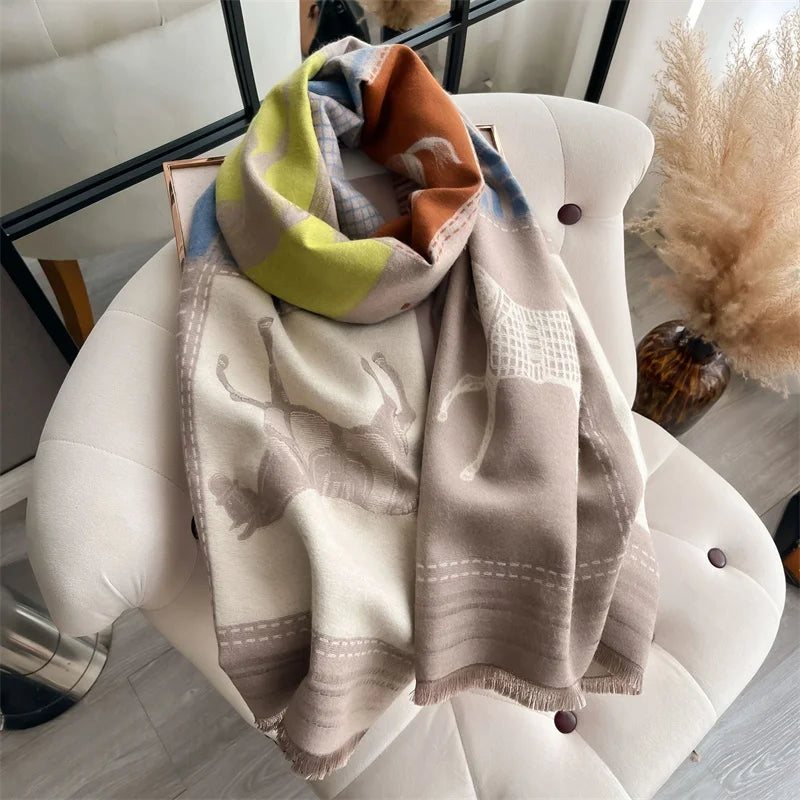 A folded luxury plaid cashmere feel scarf and shawl wrap in shades of beige, olive green, and rust.