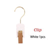 White clip with a gold hook and wooden holder for wig or hair extension