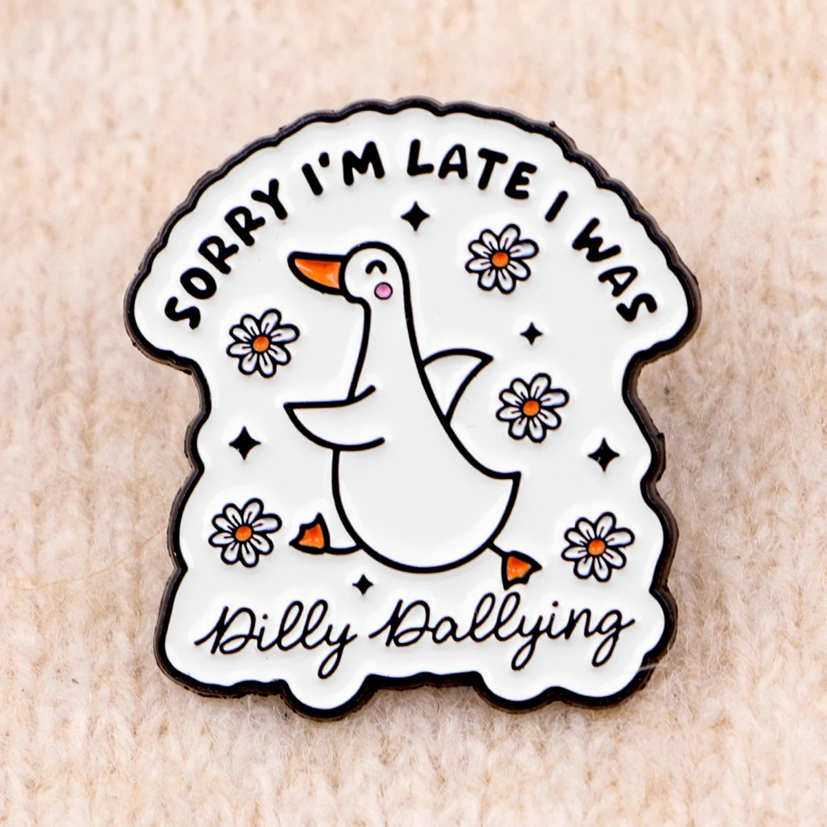 A white enamel pin featuring a duck and text that reads Sorry I'm late I was Dilly Dallying