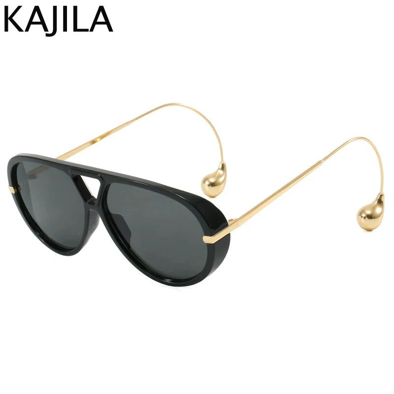 Gafas de piloto vintage negras y grandes con brazos metálicos tono dorado