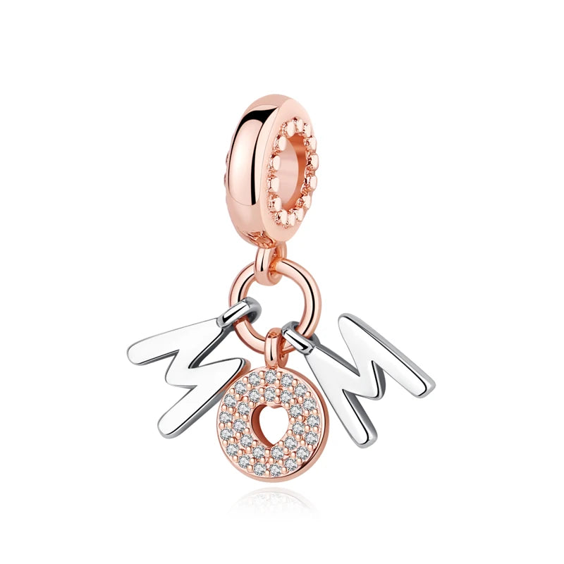 A delicate rose gold charm featuring the initials M and O, attached to a silver family tree pendant.