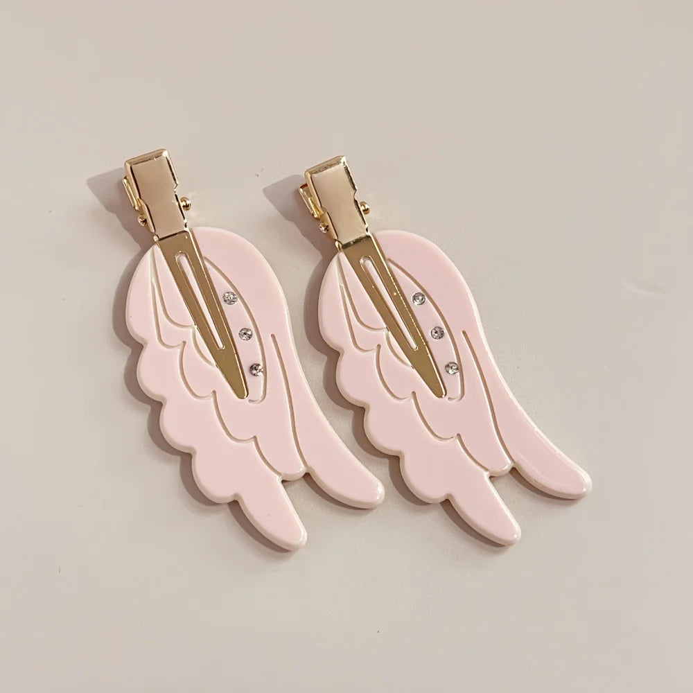 Pair of pink angel wing hair clips with gold-toned barrettes