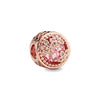 Rose gold charm pendant featuring a round, pink gemstone surrounded by floral rose gold detailing.