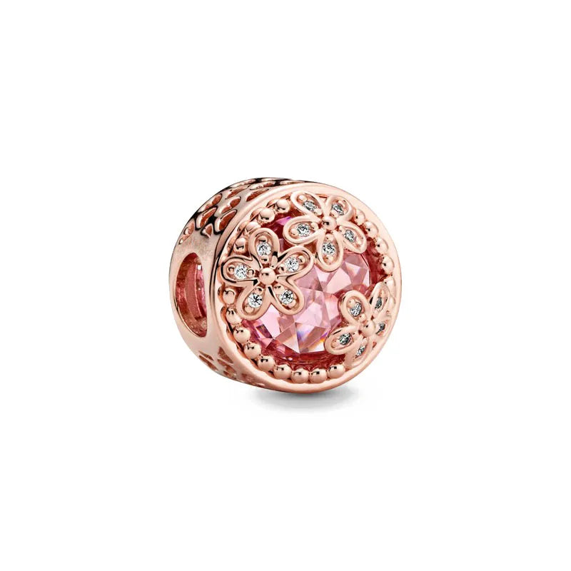 Rose gold charm pendant featuring a round, pink gemstone surrounded by floral rose gold detailing.