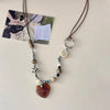 A beaded pendant necklace featuring various stones and beads on a dark brown leather cord.