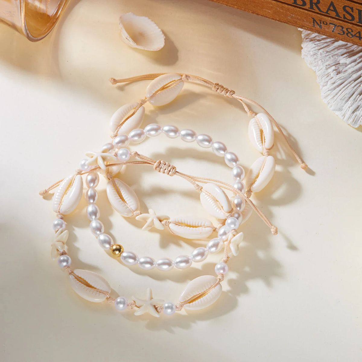 A delicate beaded anklet featuring starfish and pearl accents for summer beach wear.