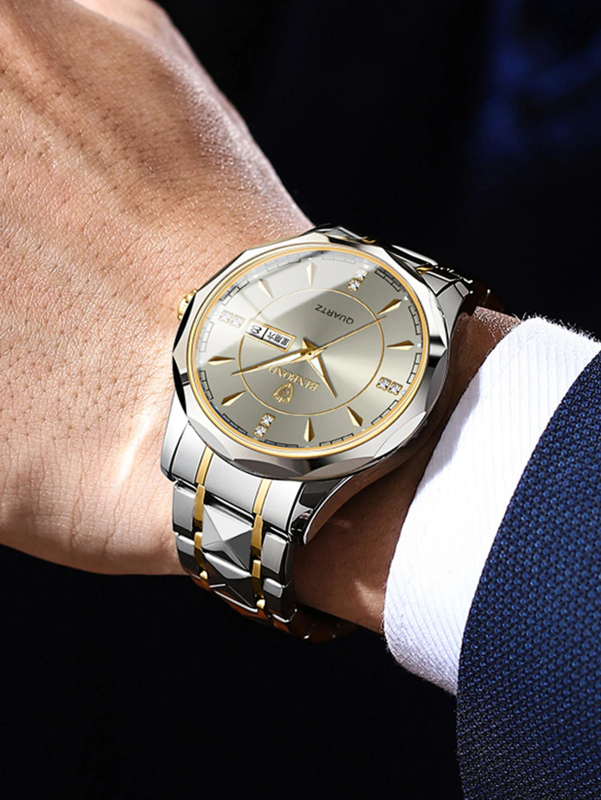 A close-up of a stainless steel quartz watch worn on a wrist, featuring a gold-toned dial and bracelet.