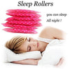 A woman is sleeping while using a set of pink sleep rollers for hair curling.