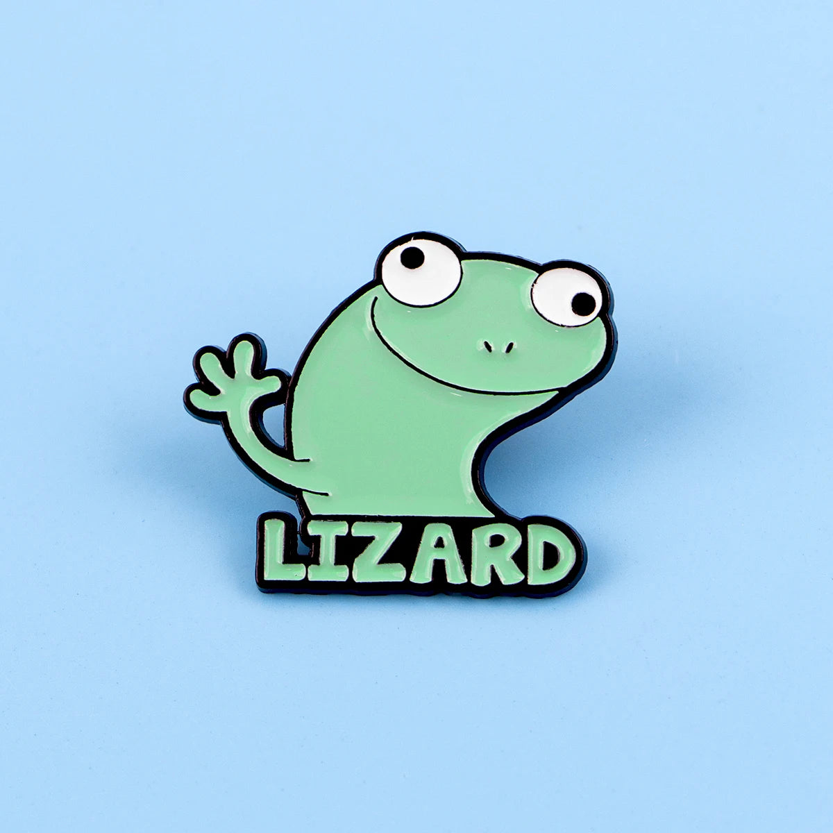 Insignia de esmalte verde claro con forma de lagarto sonriente, contorno negro y la palabra LIZARD debajo.