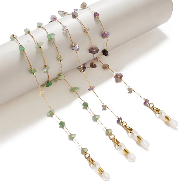 A delicate chain of natural stone beads featuring green and purple stones displayed on a white background.