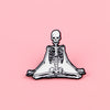A set of enamel pins depicting a full skeleton character brooch featuring bones and skull elements.