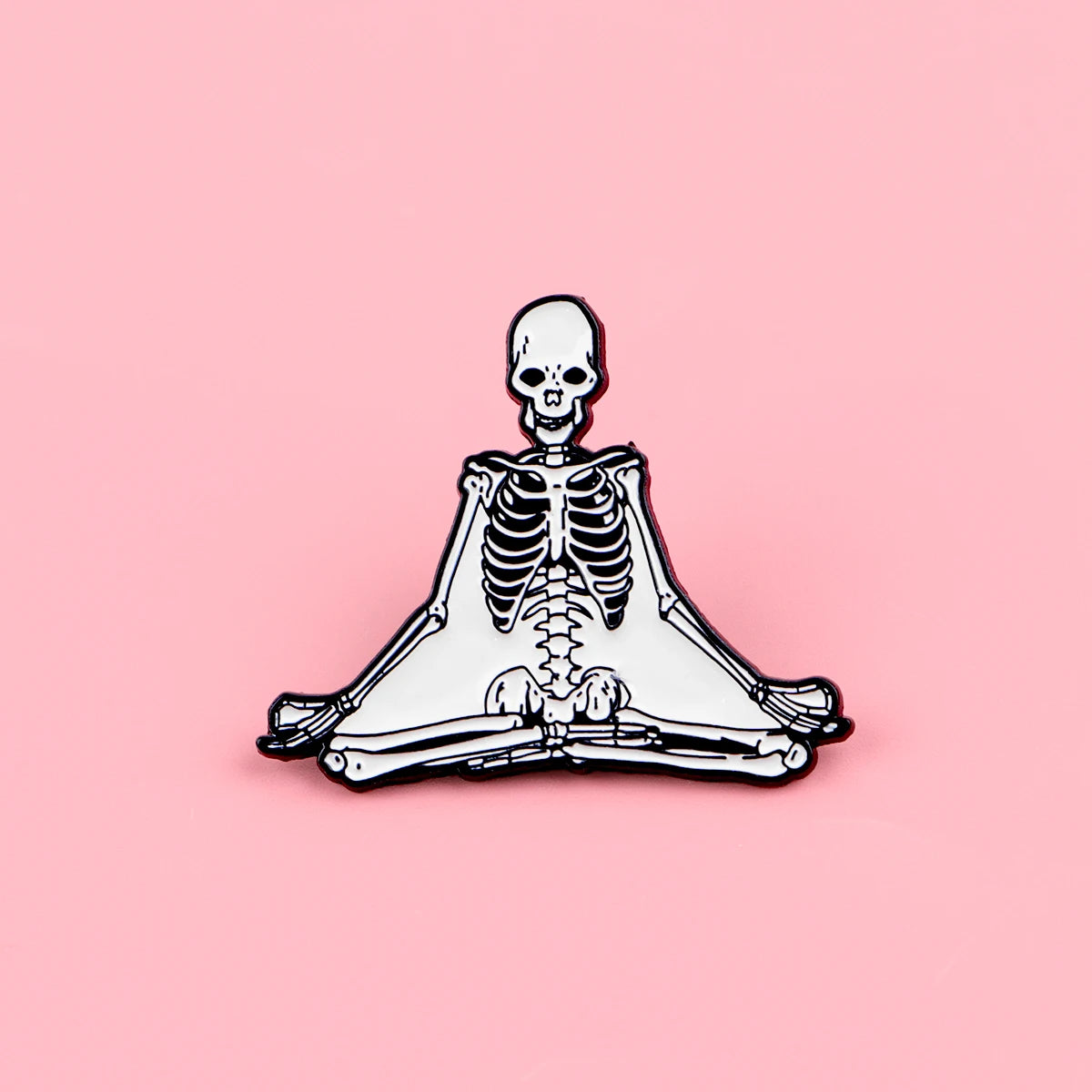 A set of enamel pins depicting a full skeleton character brooch featuring bones and skull elements.