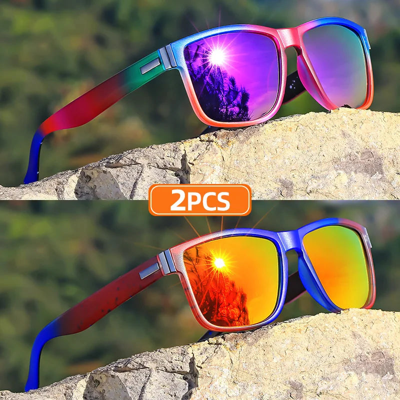 A pair of gradient square frame polarized sunglasses with vibrant rainbow colors resting on a rock.