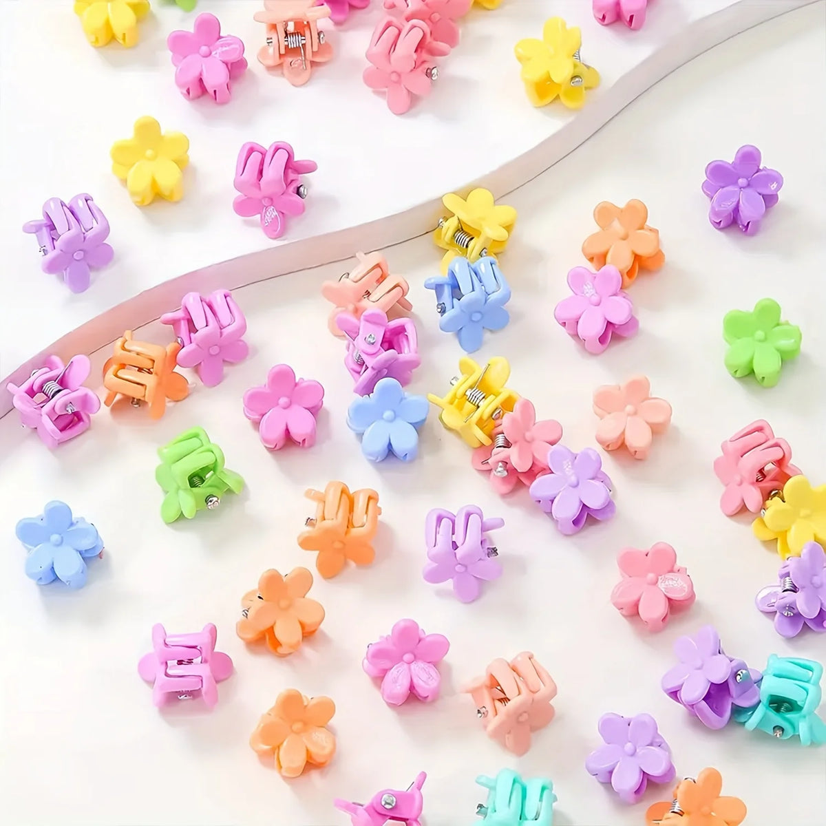 A collection of colorful decorative hair accessories shaped like flowers and other small shapes for girls