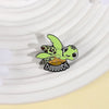 A cute green sea turtle enamel lapel pin brooch with a yellow shell and black outline.