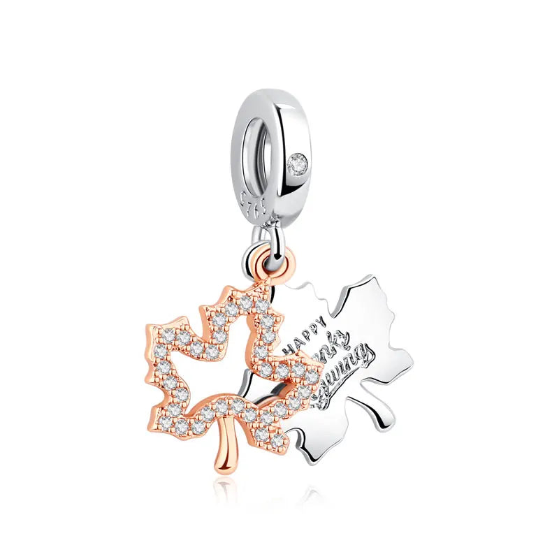 A sterling silver family tree charm necklace featuring a leaf design and a small diamond accent.