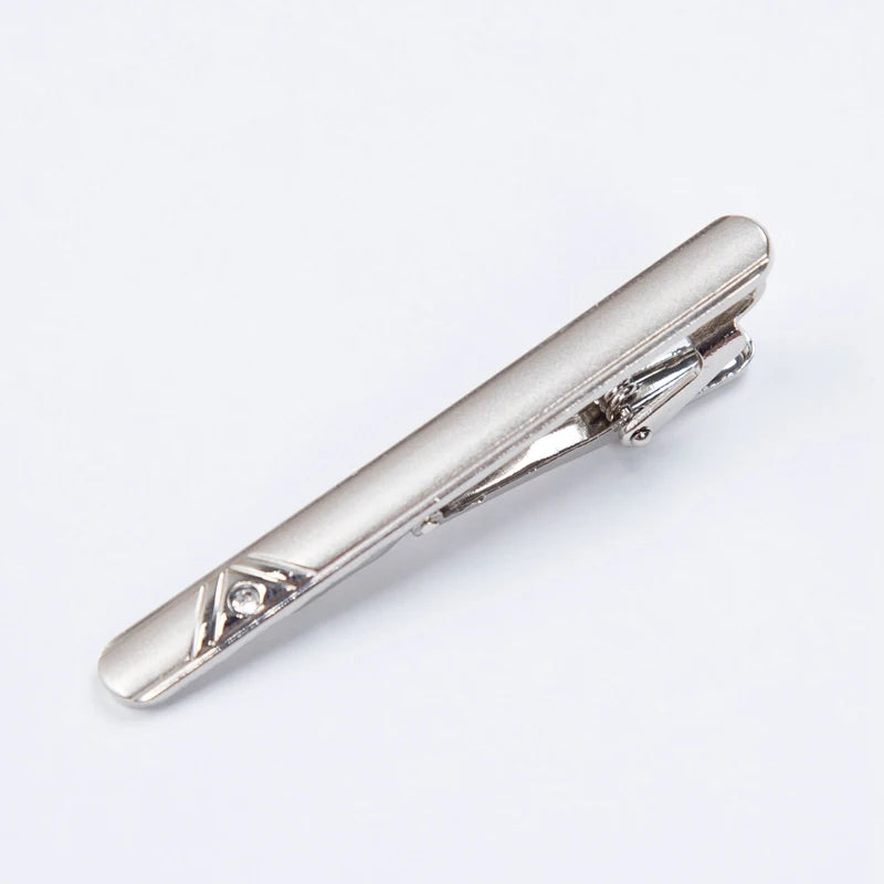 Silver metal tie clip for men's neckties with a decorative engraving.