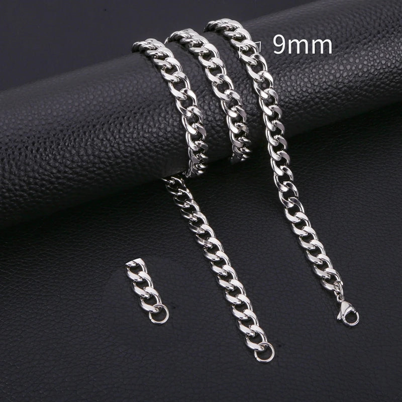 A close-up photo of a silver stainless steel Cuban link necklace with a 9mm chain, displayed on a black surface.