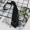 A black classic chain necktie accessory is displayed against a light background with a grid pattern.