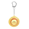 Gold metal keychain featuring an anime style straw hat design.