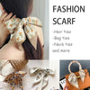 A collection of silk satin hair ties, bag ties, and neck ties in various patterns and colors.
