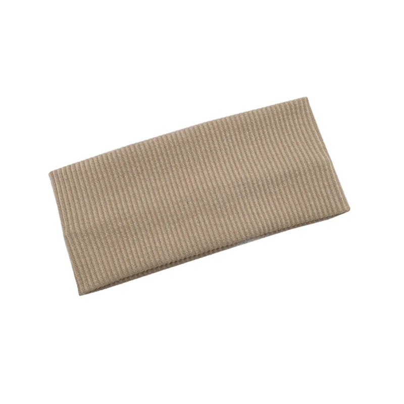 A beige knitted sports headband for yoga and gym