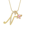 Gold letter pendant necklace featuring a personalized letter and a pink gemstone charm