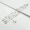 A delicate silver chain featuring round metal beads used for eyewear or sunglasses.