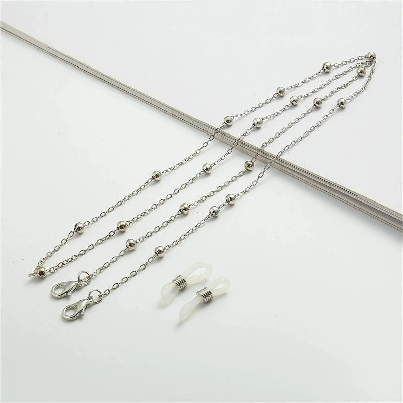 A delicate silver chain featuring round metal beads used for eyewear or sunglasses.