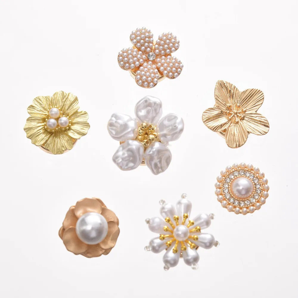 A collection of floral button cufflinks featuring pearl and gold accents.