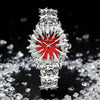 Silver quartz wristwatch featuring a dragon scale design on a red background, set against a backdrop of clear crystals.