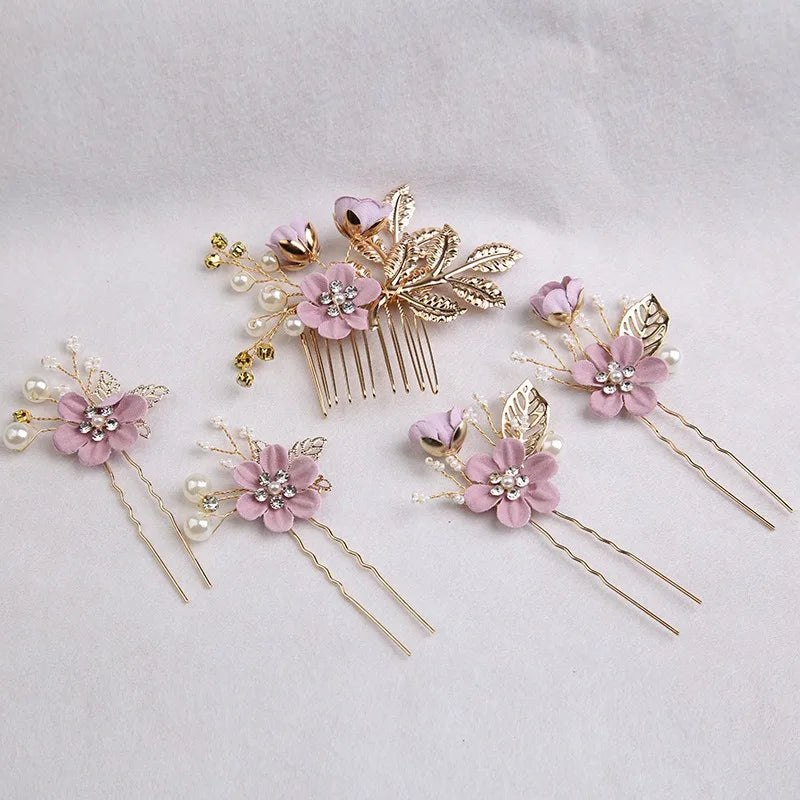 A set of five floral pearl bridal hair accessories featuring pink flowers and gold accents.