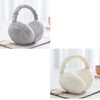 A pair of plush fur ear warmers or earmuffs in gray and white are shown on a surface.