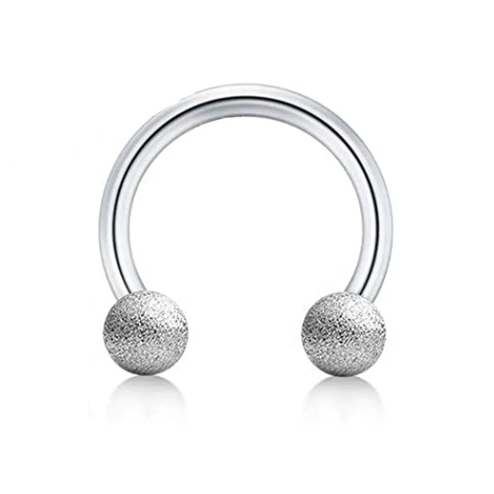 Silver barbell ring set with a smooth curved bar and two textured spherical ends