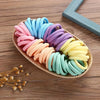 A colorful display of boho seamless elastic hair ties in various shades of pink, blue, purple, and yellow arranged on a woven