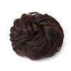 A dark brown, messy bun hairstyle made from hair pieces.
