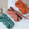 Three orange and pink PU leather eyewear pouches and glasses cases displayed on a white background.