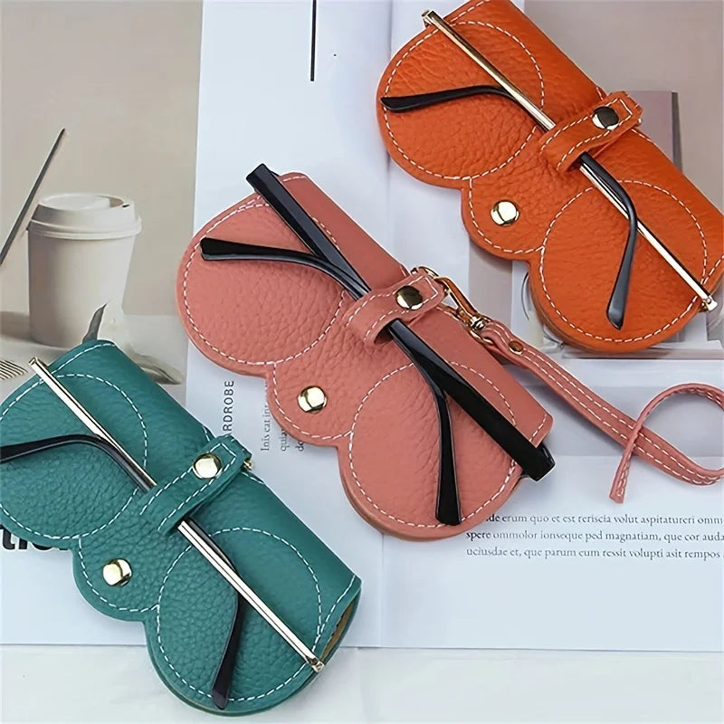 Three orange and pink PU leather eyewear pouches and glasses cases displayed on a white background.