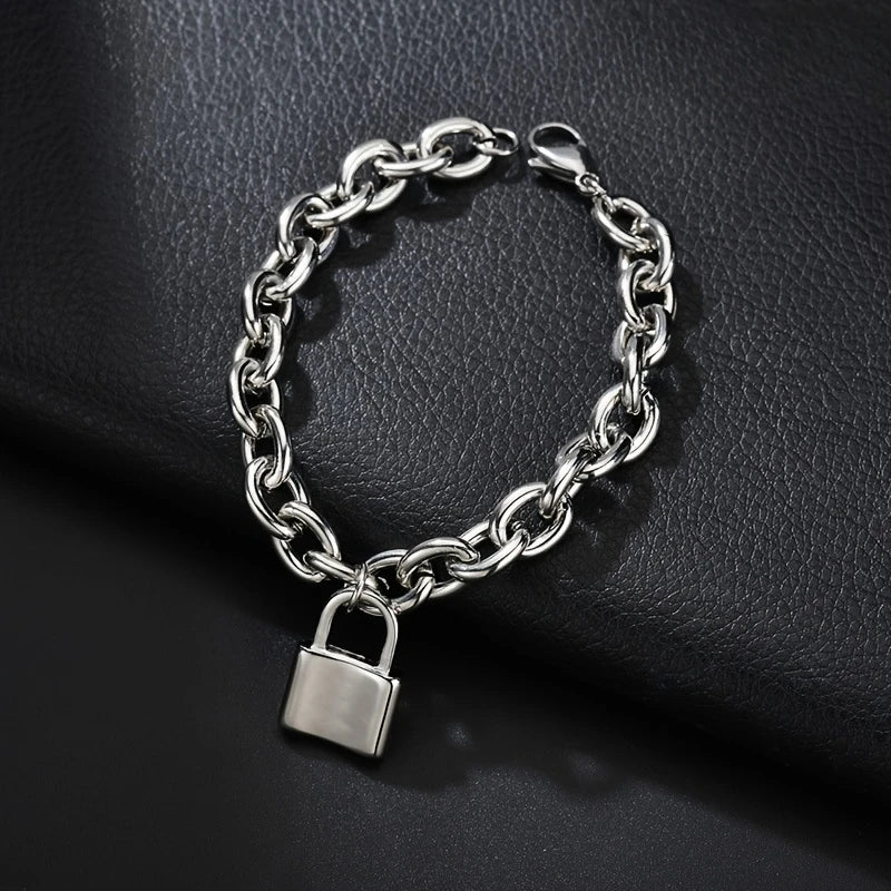 A silver charm lock bracelet made of 925 sterling silver chain and a padlock displayed on a dark surface.
