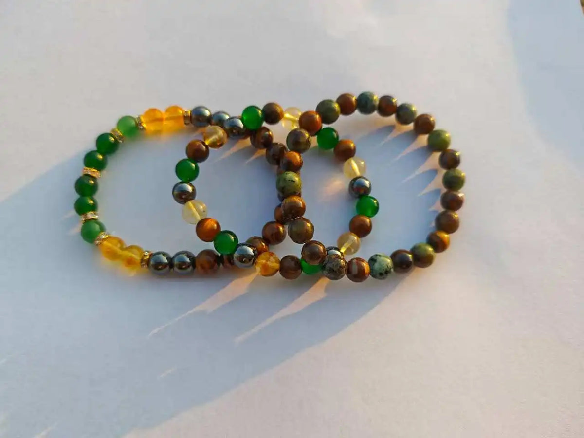 Collection de bracelets déclaration avec des perles de citrine et d'œil de tigre dans diverses nuances de vert, jaune et