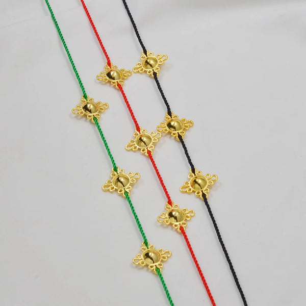 Traditional Ethiopian head chain featuring gold-colored floral charms strung on colored threads.