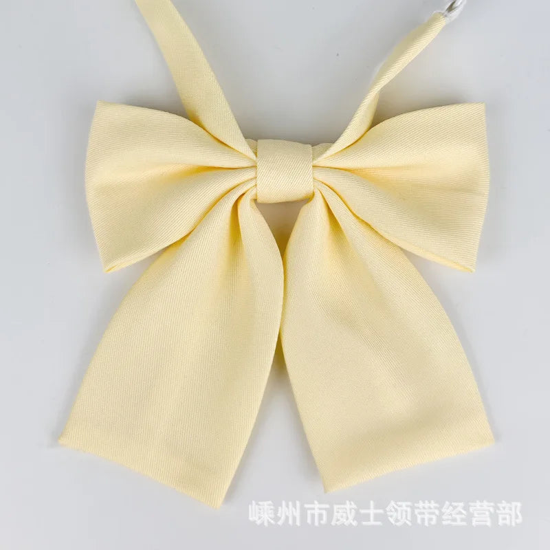 A yellow butterfly ribbon tie set with a bow and a strap for students.