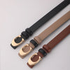 A close-up of a women's smooth double-sided belt with a C-shaped gold buckle shown in various leather colors.