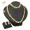 A gold heart crystal jewelry set featuring a delicate necklace and earrings displayed on a black stand.