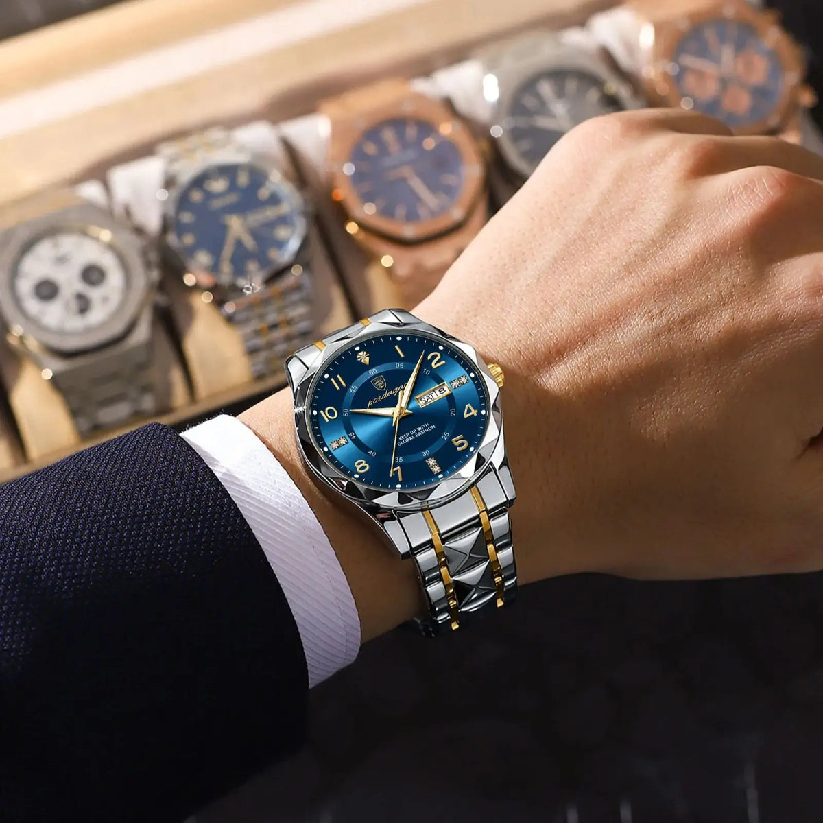A close-up of a luxury men's blue quartz watch with a luminous dial resting on a wooden display with other watches.